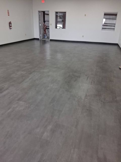 Empty commercial interior with clean gray plank floors