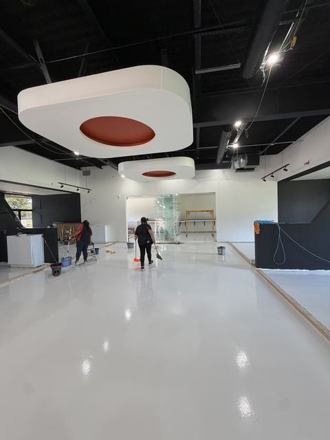 Glossy white epoxy floor in a commercial space after post-construction cleaning