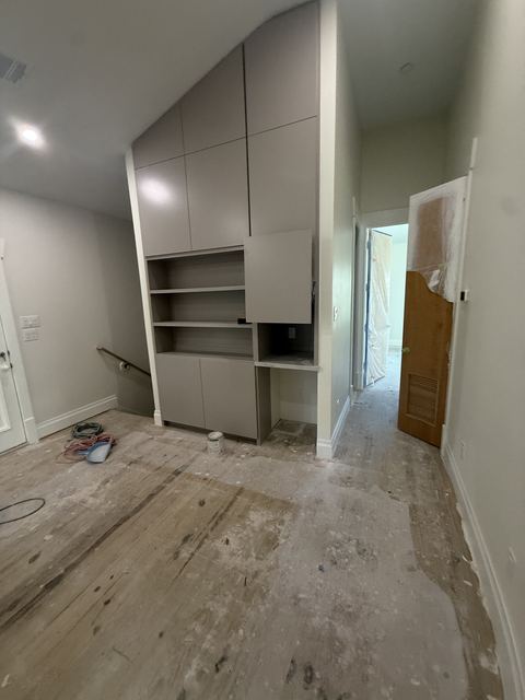 New built-in cabinets with dust and splatter on the floor