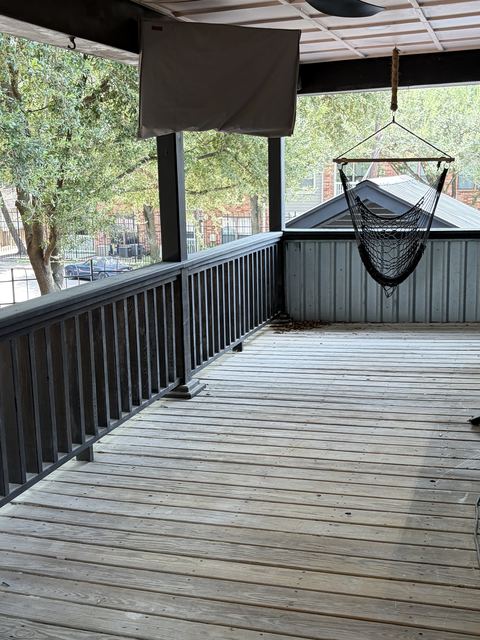 Covered wooden deck with railing awaiting exterior cleanup