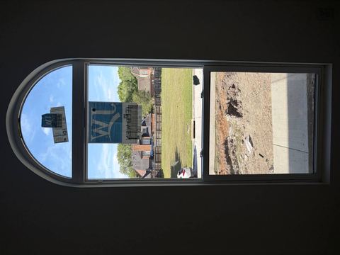 New arched window with manufacturer stickers still attached
